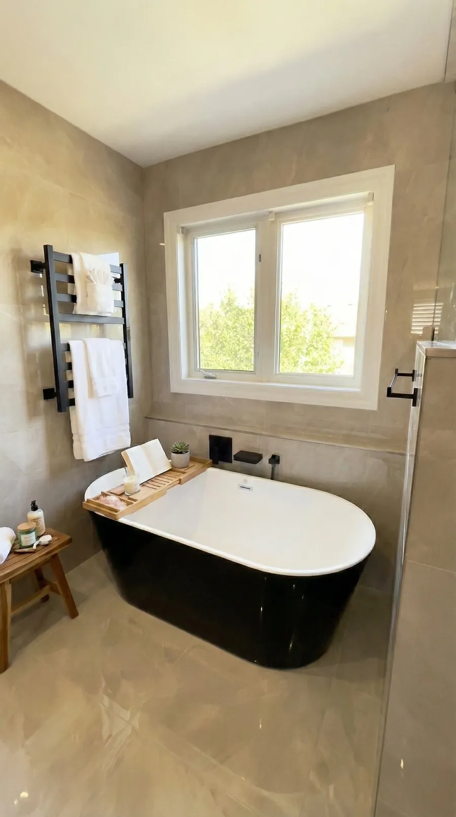 Black freestanding bathtub in a North York bathroom renovation